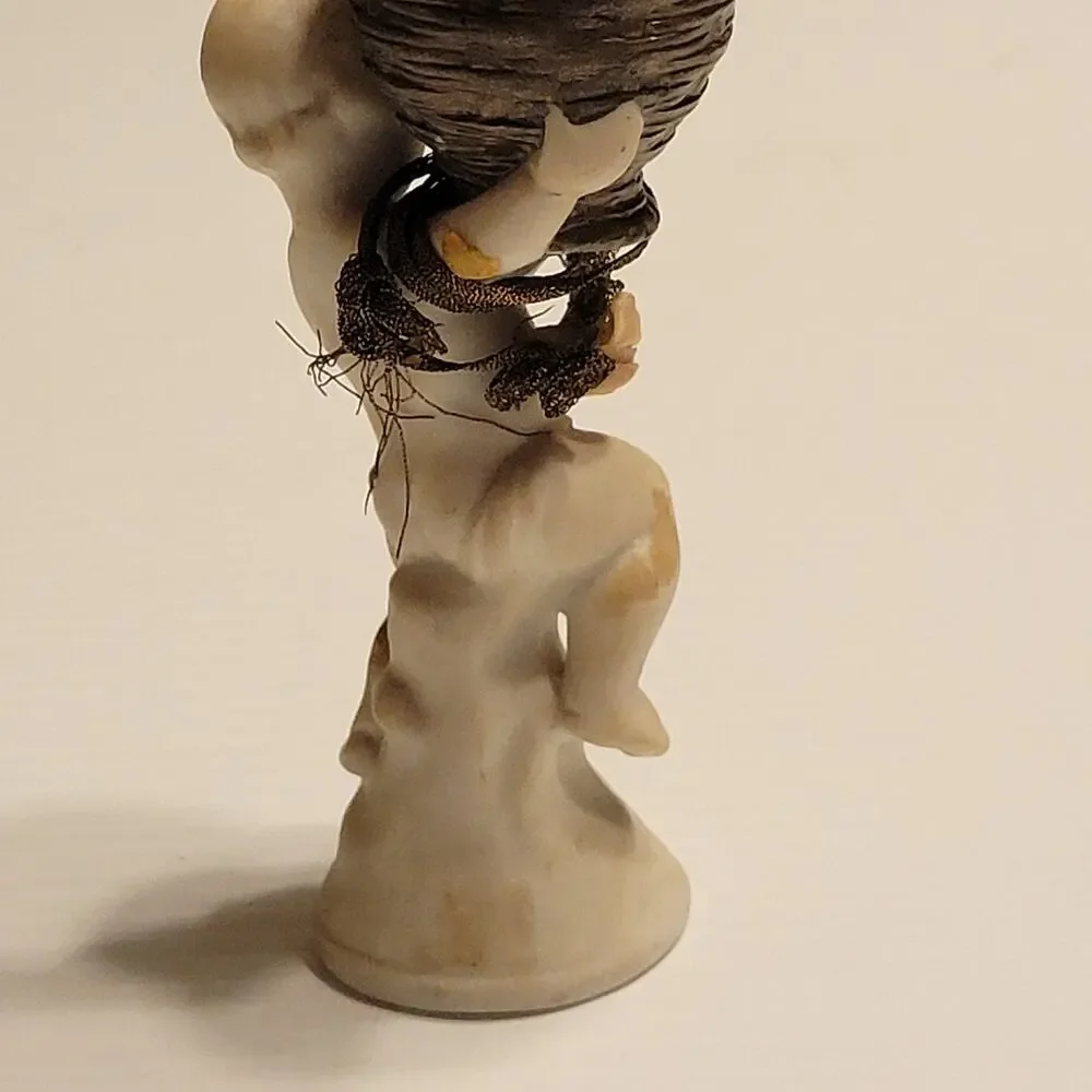 Vintage child cherub figurine with vase
